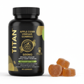 Black bottle of TITAN Apple Cider Vinegar Gummies with gold text and graphics next to three sugar-coated gummies.
