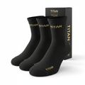Three black ribbed ankle socks with gold "TITAN" logo at the cuff and toe, presented with branded black packaging.