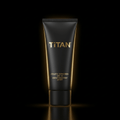 Matte black tube of TITAN Athletic Sunscreen SPF 50 with gold lettering, backlit on a black background.