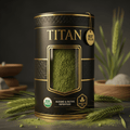 Black canister of Titan Organic Barley Grass Powder with gold text, viewing window, and barley stalks on dark surface.
