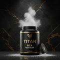 Titan BCAA black tub with gold lettering and white powder erupting against a dark, gold-veined marble background.