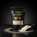 Black pouch of TITAN organic chia seed protein with gold text, clear window, and scoop of powder on dark background.