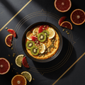 Citrus power bowl topped with kiwi, lemon, and blood orange slices, sprinkled with seeds on a gold-lined black table.