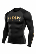 Black long-sleeve compression shirt with gold "TITAN GLOBAL" logo on chest and sleeve, featuring a globe icon.