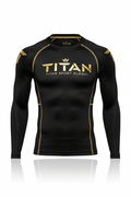 Black long-sleeve compression base layer with gold TITAN logo, crown graphic, and gold stitching accents.