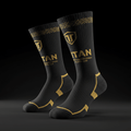 Black Titan performance compression socks with gold geometric cuffs, brand logo, and gold heel and toe accents.