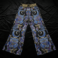 TITAN Crown Edition palazzo pants featuring blue and purple owl and crescent moon tattoo art on a black background.