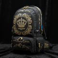 Black hiking pack with gold crown logo, ornate filigree, mountain graphics, and metallic gold zippers.
