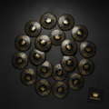 Twenty black flat disc cones with gold crown logos and intricate decorative patterns, arranged on a dark background.