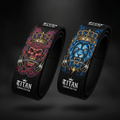 Two Titan Crown Edition black figure-8 lifting straps with skull-snake and lion graphics holding barbells in teeth.