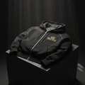 Black zip-up hoodie featuring a gold crown logo and the motivational text "Greatness is my only option."