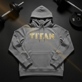 Grey performance fleece hoodie featuring gold "TITAN" chest logo, matching gold drawstring aglets, and front pouch.