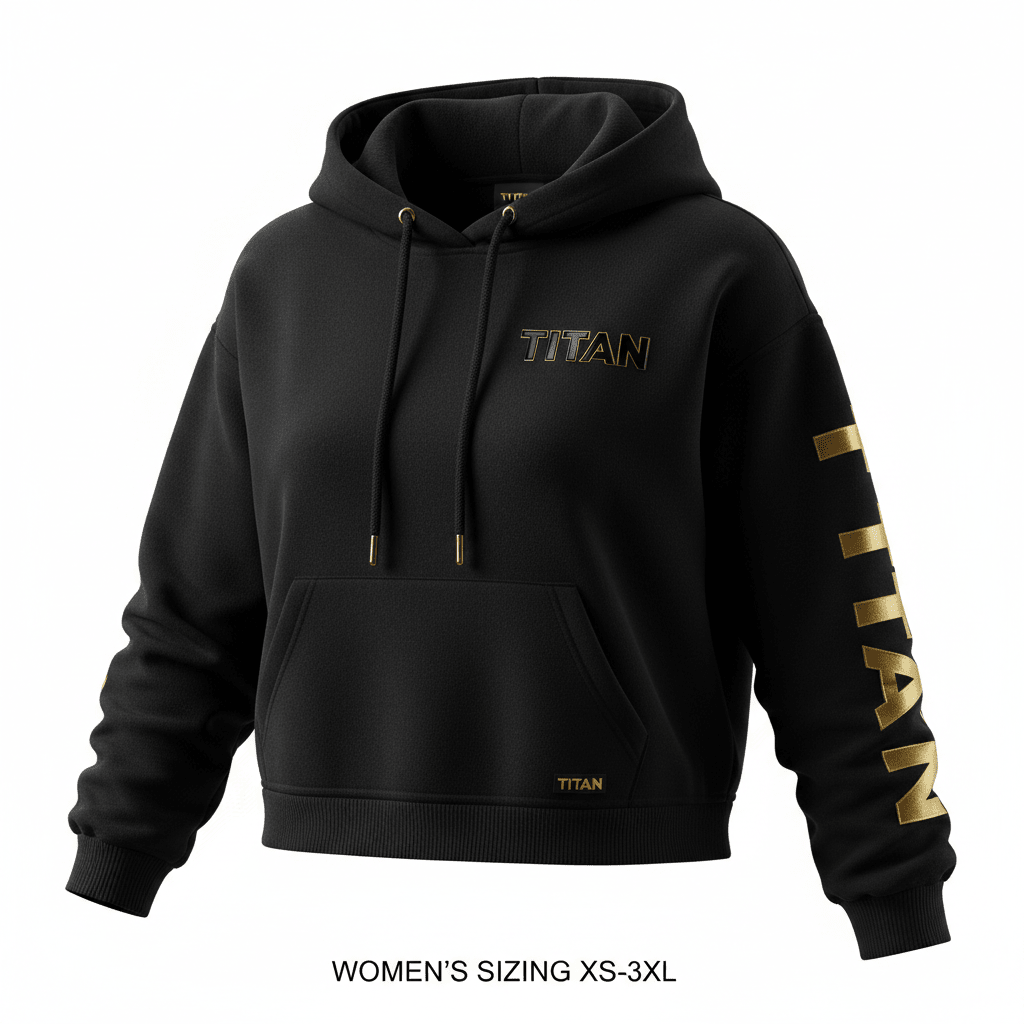 Black cropped hoodie featuring a metallic gold chest logo, sleeve text, drawcord tips, and a small hem tag.