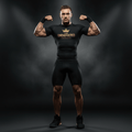Athlete wears a black compression shirt with gold "I AM UNDEFEATED" crown graphic, promoting a warrior mindset.