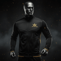 Black zip-up track jacket with a gold crown logo and "I WAS BORN READY" text on a male mannequin.
