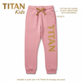 Pink TITAN kids sweatpants featuring an elastic waistband with gold drawstring, side pockets, and gold leg logo.