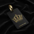 Black matte luggage tag with a gold, jewel-encrusted crown design and TITAN SPORT GLOBAL logo on black silk.