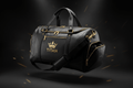 Black TITAN luxury gym bag with gold zippers, hardware, and a prominent gold crown logo on a dark background.