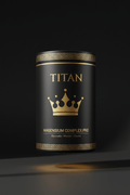Black canister with gold Greek key trim, crown logo, and Titan Magnesium Complex text on a dark background.