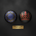 Two black massage balls: one with a blue/gold mandala, one with a red/gold crown design, above a gold brand plaque.