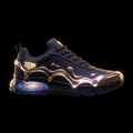 TITAN Classic sneaker in black with gold metallic drip overlays, glowing brand logo, and a galaxy-print sole.