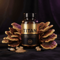 TITAN Mesima Mushroom bottle with gold and black label, surrounded by bracket mushrooms and capsules on black fabric.