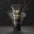 Black tube of Titan Muscle Rub with gold helmet logo, text, and smoky effect on a dark, speckled background.
