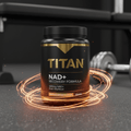 Black TITAN NAD+ supplement tub with gold lettering, encircled by glowing orange rings on a dark gym floor.