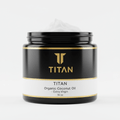 Black jar of Titan Organic Extra Virgin Coconut Oil with gold branding and white label, featuring a scoop of white oil.