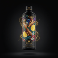 Black bottle of TITAN Ginger Lemon kombucha with vibrant floral, ginger, and lemon graphics against golden light rings.