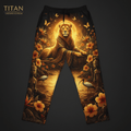 Black lounge pants featuring a majestic lion, golden sun, tropical flowers, ibises, and statues in warm gold tones.