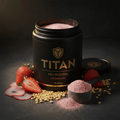 Black container of Titan Strawberry Pea Protein with a measuring scoop of pink powder, fresh strawberries, and peas.