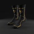 Black TITAN performance compression socks with gold lion logo, branding, and geometric accent lines.