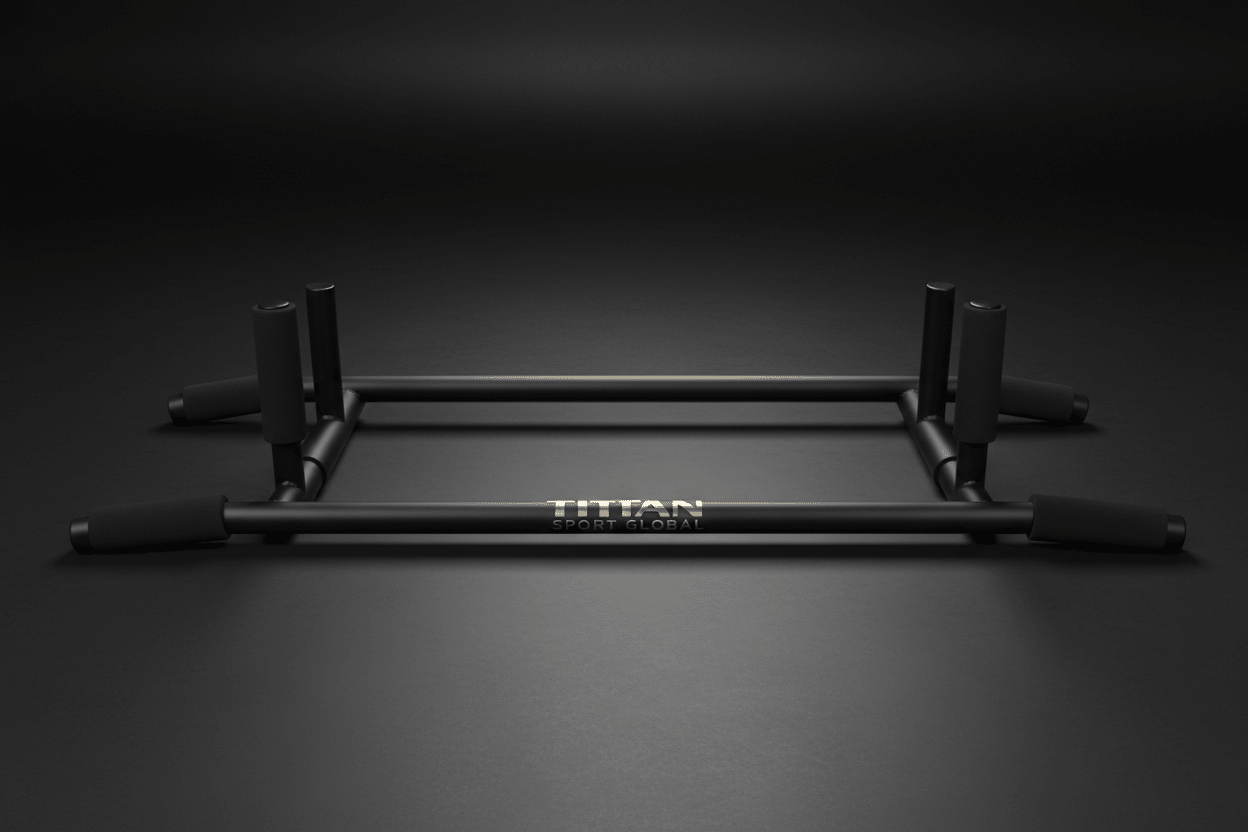 Matte black TITAN Pro pull-up bar with foam-padded grips and gold logo, centered on a dark studio background.