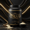 Black tub of TITAN Vanilla Protein Powder with gold ornate lettering on a marble surface against black wavy fabric.