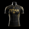 Black short-sleeve rashguard with gold "TITAN" branding, lion head logo, and gold athletic accents on a mannequin.