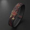 Black silicone watch band with red crown icon and gold geometric lightning patterns, featuring TITAN logo loop.