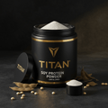 Black jar of TITAN Soy Protein Powder with gold logo, open lid, scoop, and scattered soybeans on dark surface.