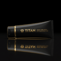 Matte black TITAN sport hand cream tube with gold logo and text, featuring a reflective base on a black background.