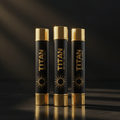 Three black and gold TITAN Sport lip balm tubes with sun logo, vertically aligned on a dark, reflective surface.