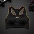 Black high-impact TITAN racerback sports bra with gold logo, mesh side panels, and glowing amber trim.