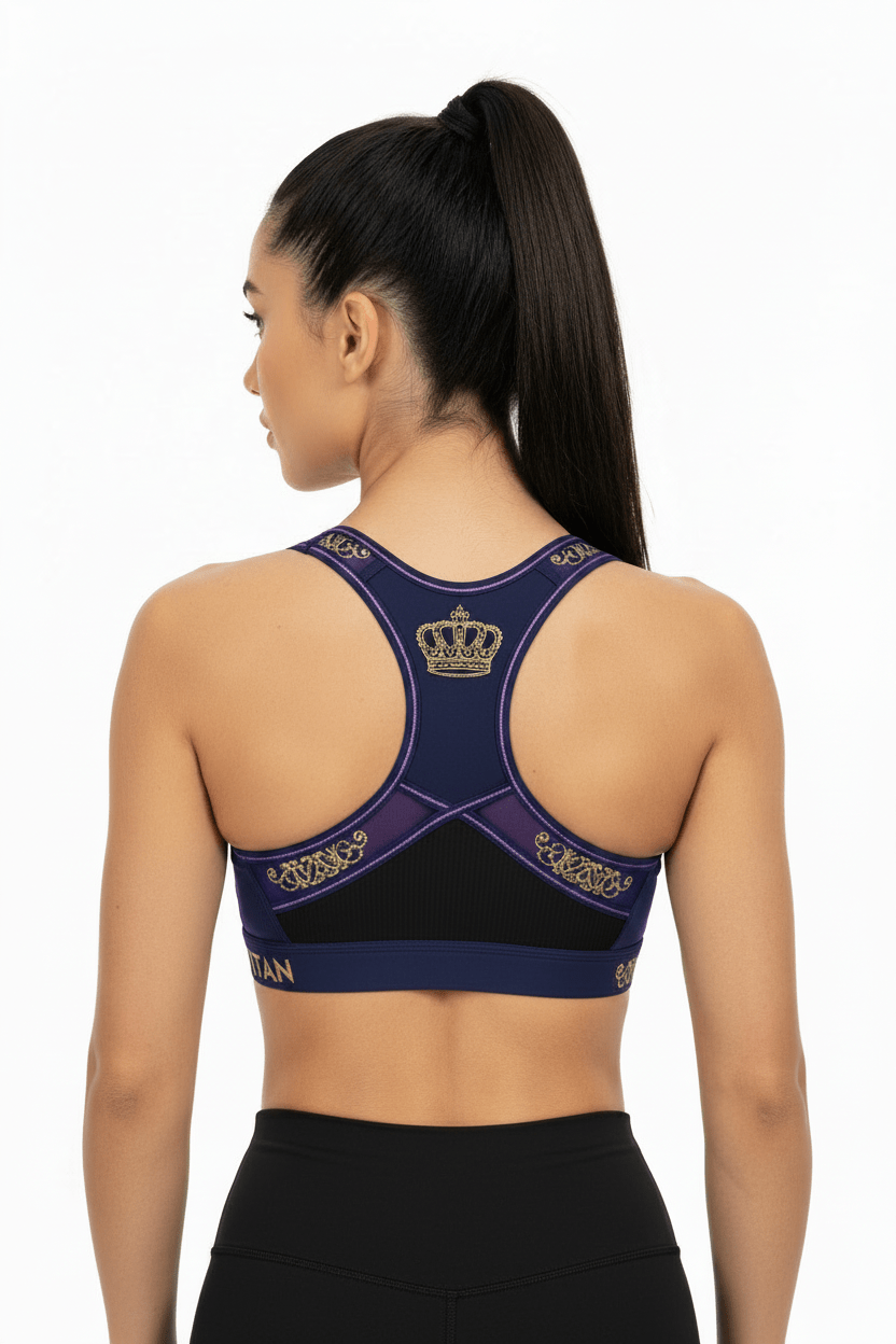 TITAN Midnight Royale sports bra: navy racerback with gold crown logo, filigree accents, and mesh panel back detail.
