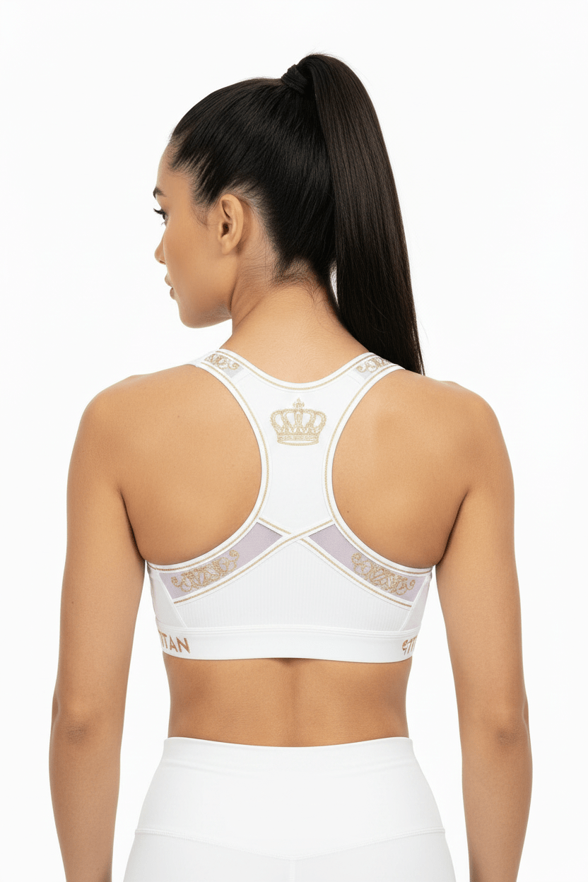 TITAN white racerback sports bra featuring gold crown logo and detailing on back, worn by model.