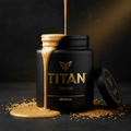 Creamy tahini drips from a sleek black TITAN jar with gold logo and text, surrounded by sesame seeds on a dark surface.