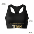 Black racerback sports bra with gold "TITAN" logo on elastic band, removable padding, and medium support labels.