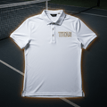 White performance tennis polo with a button placket and gold "TITAN" logo on a tennis court background.