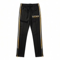 Black TITAN track pants with gold side stripes, drawcord waist, metallic leg zips, and gold "TITAN" thigh logo.