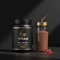 Black TITAN vegan protein tub with gold branding, beside a chocolate smoothie in a glass with a gold straw and berries.