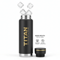 32oz black insulated TITAN water bottle with gold logo and matching lid, ice cubes floating above, white background.