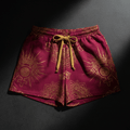 Magenta lounge shorts with a metallic gold crown, floral, and emblem print, featuring an elasticized gold drawstring.